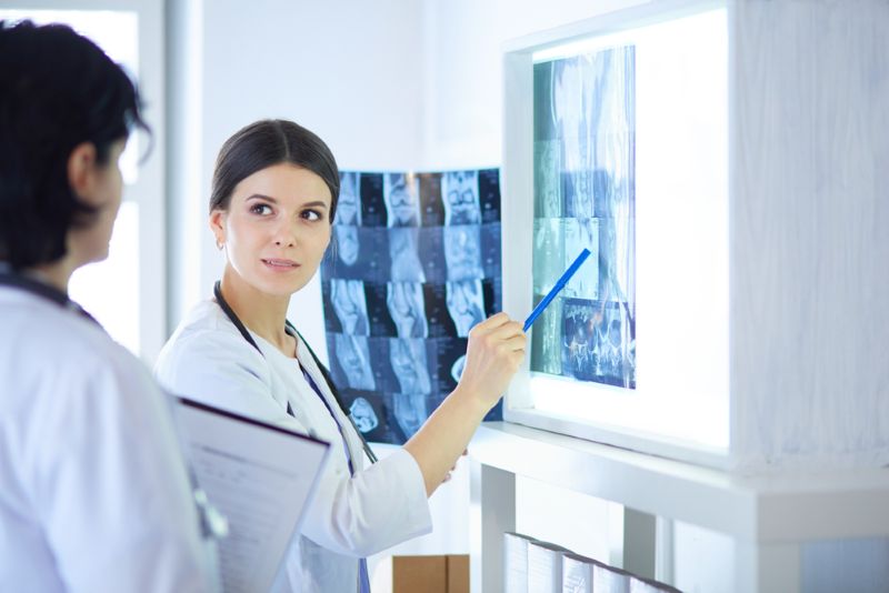 Two doctors examining xrays in a hospital