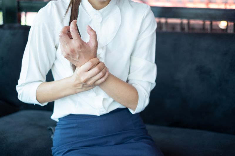 Businesswoman holding her wrist in pain